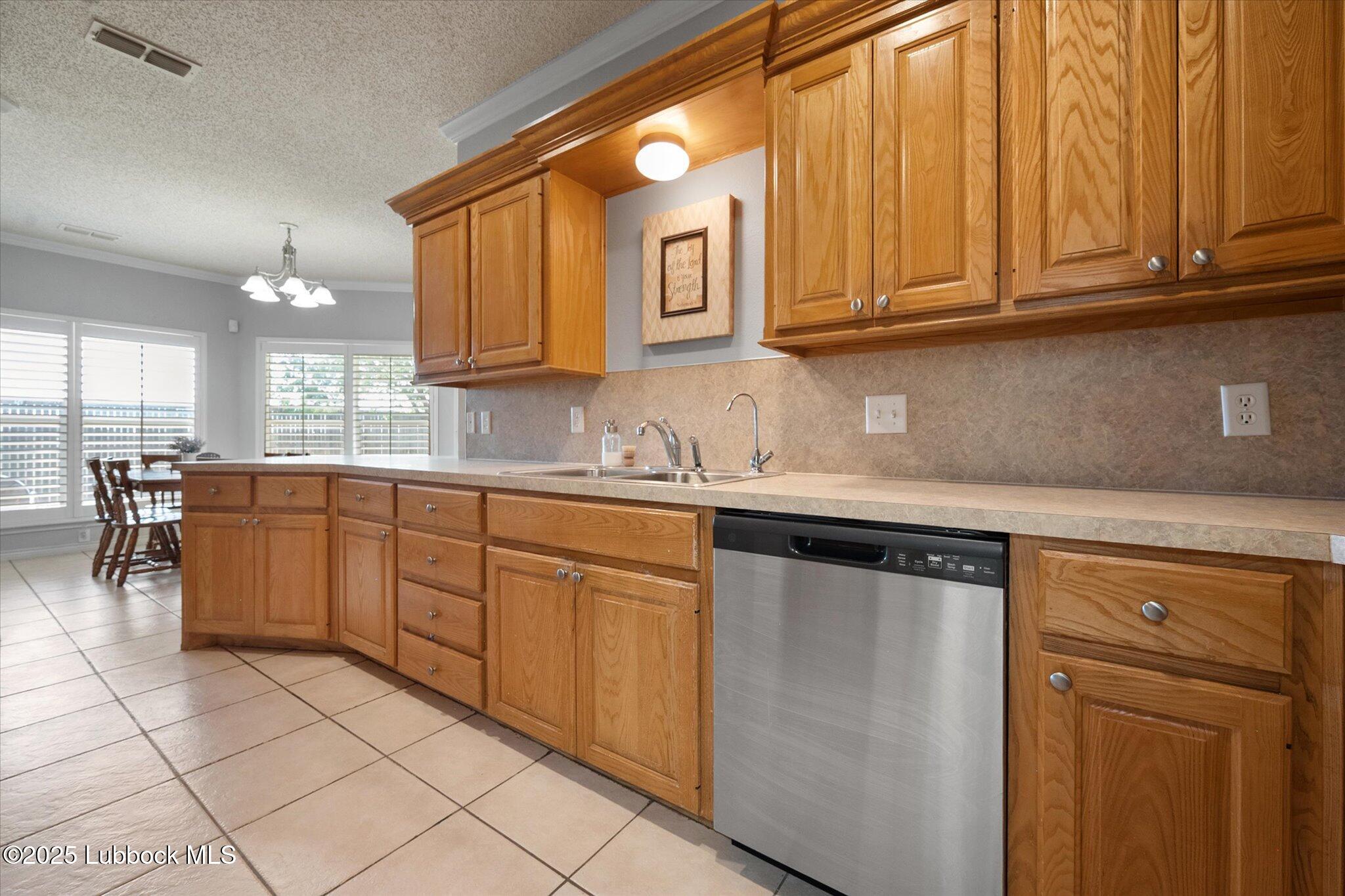 10401 Elgin Avenue Lubbock, TX 79423 - Photo 12 of 27 a kitchen with stainless steel appliances granite countertop a sink and cabinets