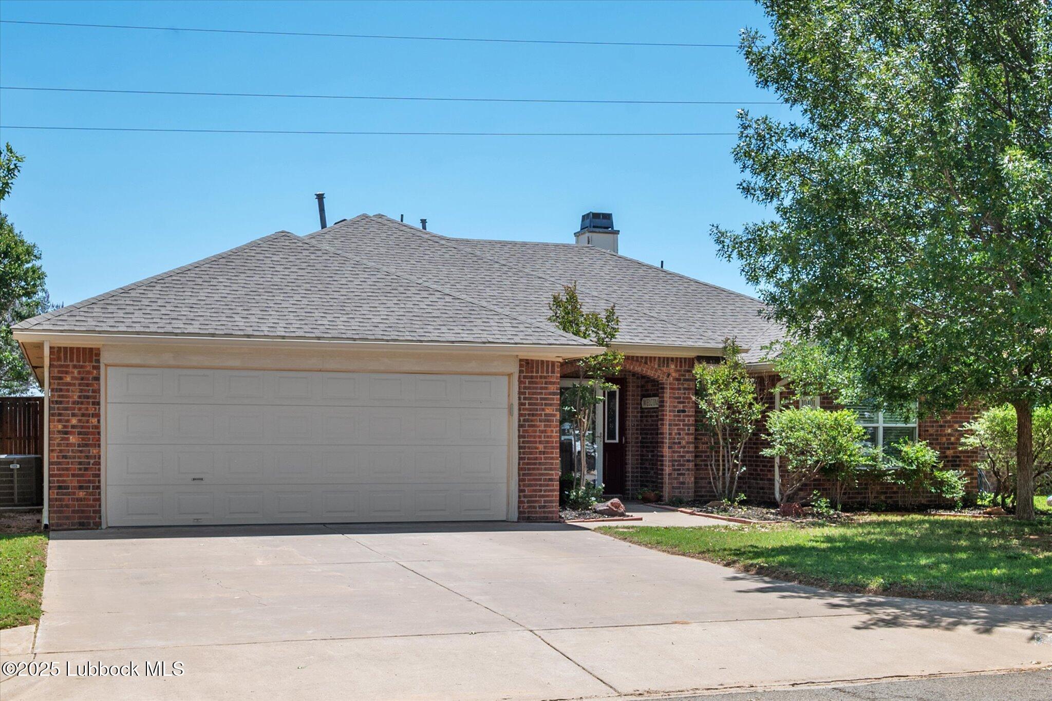 10401 Elgin Avenue Lubbock, TX 79423 - Photo 2 of 27 a front view of a house with a yard and garage