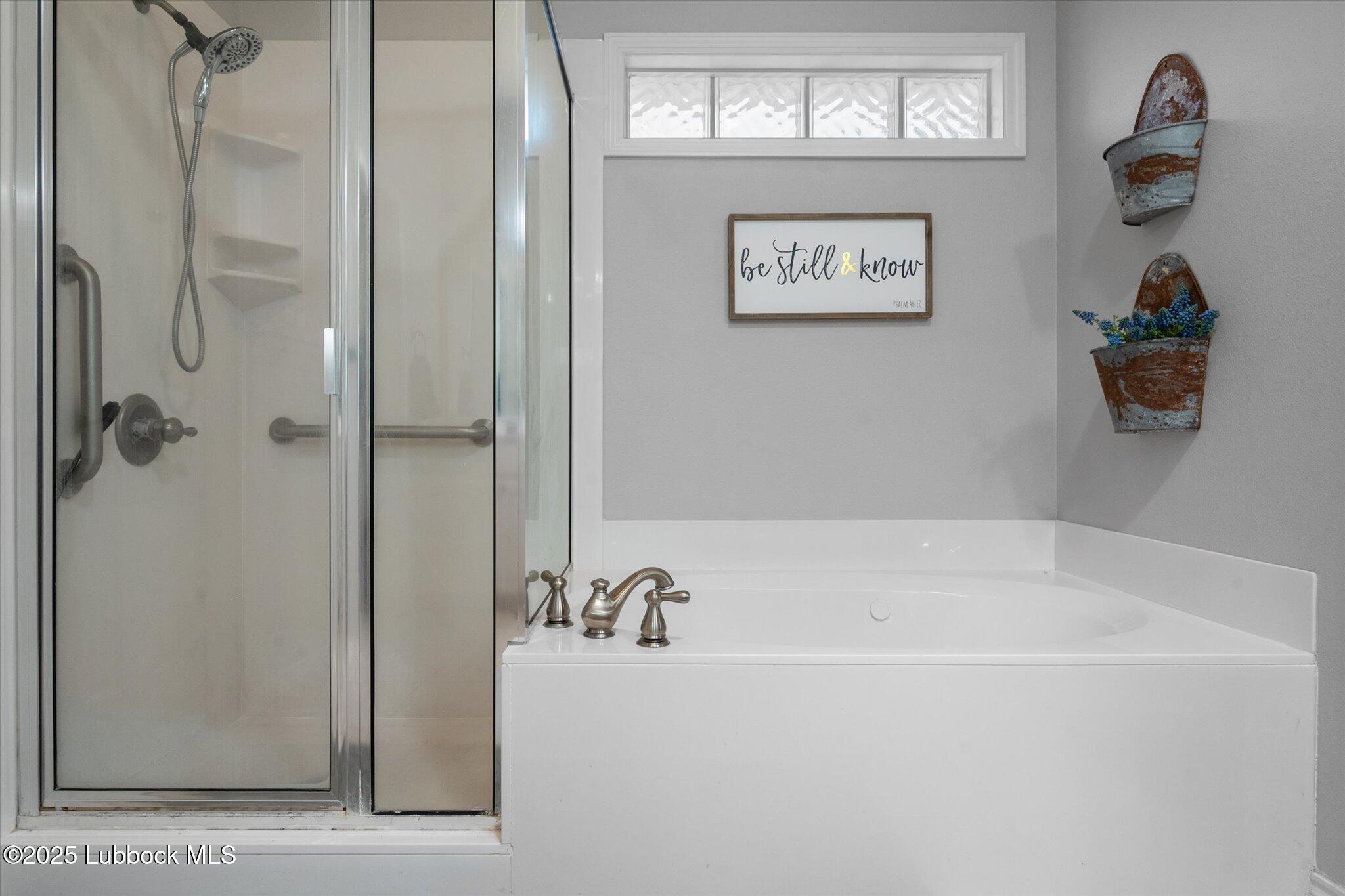 10401 Elgin Avenue Lubbock, TX 79423 - Photo 21 of 27 a bathroom with a bathtub and a shower
