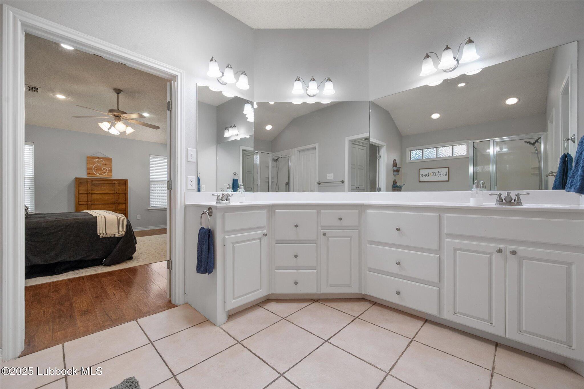 10401 Elgin Avenue Lubbock, TX 79423 - Photo 23 of 27 a bathroom with a sink vanity and mirror