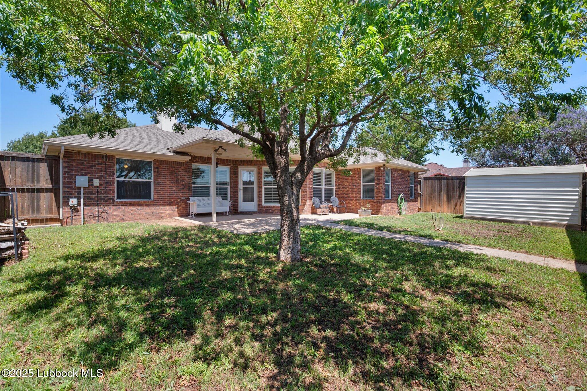 10401 Elgin Avenue Lubbock, TX 79423 - Photo 25 of 27 a front view of a house with garden