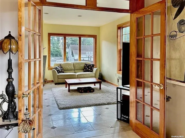 a living room with furniture a rug and a window