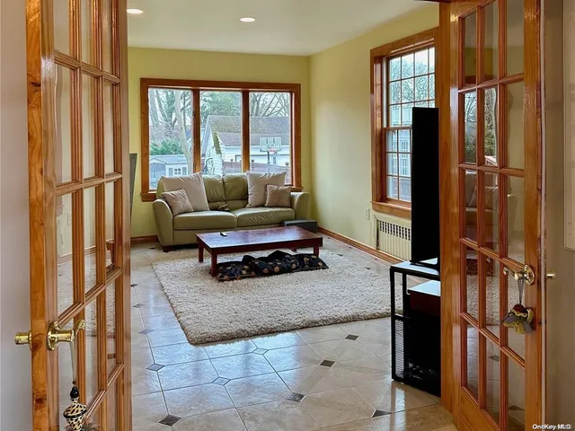 a living room with furniture rug and a window