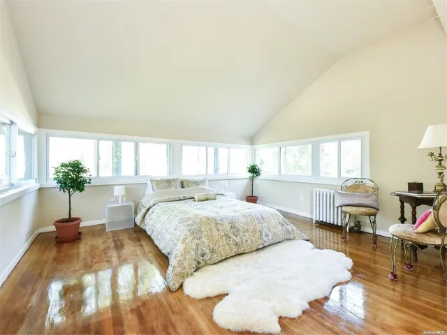 a spacious bedroom with a bed and a window