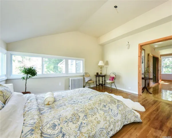 a bed sitting in a bedroom next to a window