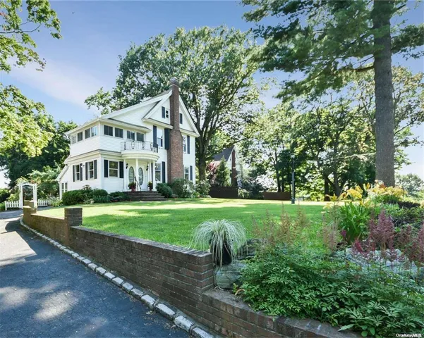 a front view of a house with a yard table and chairs