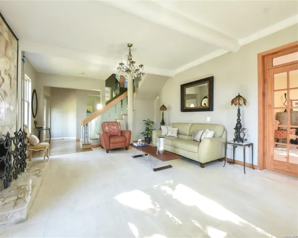 a living room with furniture and a chandelier