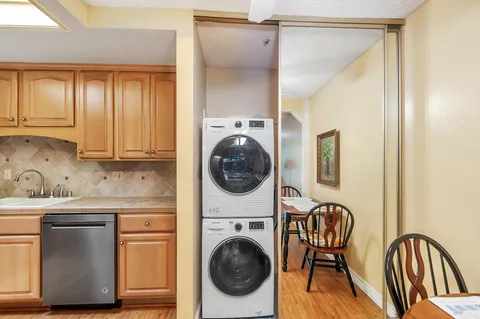 a utility room with sink dryer and washer