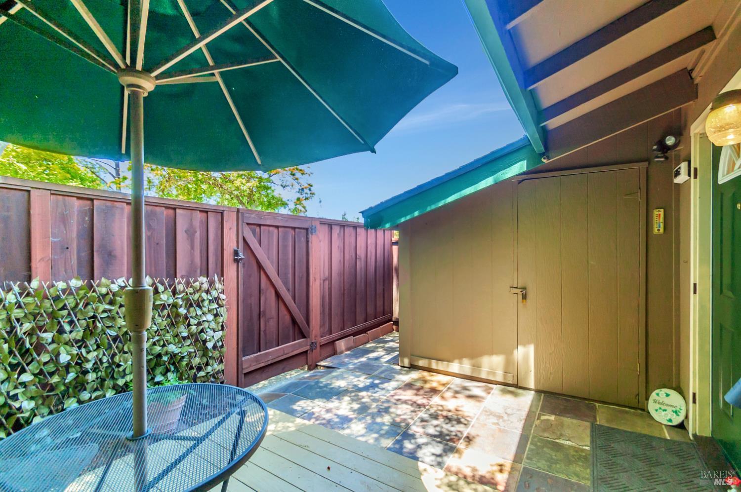 6162 Country Club Drive Rohnert Park, CA 94928 - Photo 4 of 19 a backyard of a house with table and chairs under an umbrella