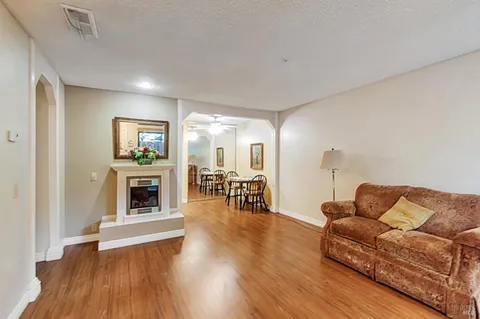 a living room with furniture and a fireplace