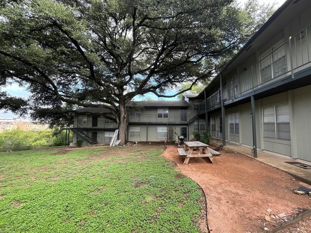 509 Cedar Drive, Unit 206 Georgetown, TX 78628 - Photo 1 of 1 a backyard of a house with table and chairs