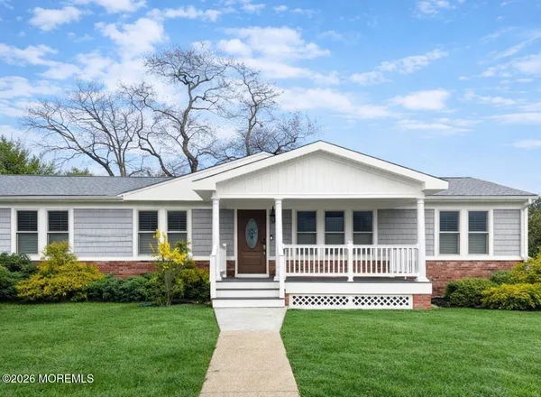 a front view of a house with a yard and porch