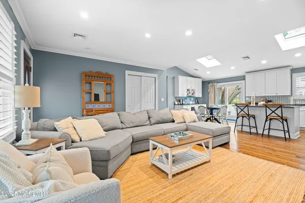 a living room with furniture kitchen view and a table