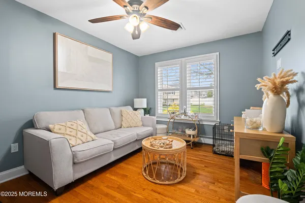 a living room with furniture a chandelier and a window
