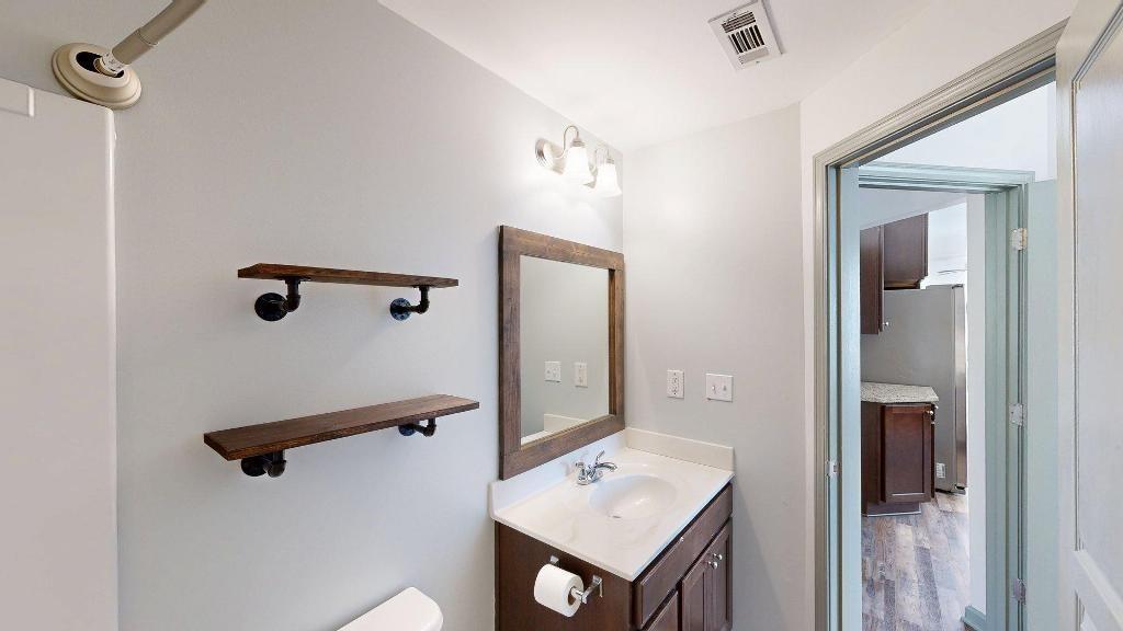 2499 Sinclair Trace Powder Springs, GA 30127 - Photo 17 of 42 a bathroom with a shower sink and mirror