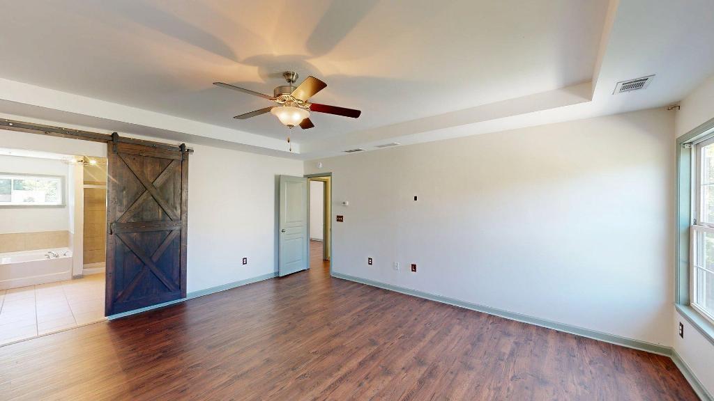 2499 Sinclair Trace Powder Springs, GA 30127 - Photo 21 of 42 an empty room with wooden floor and windows