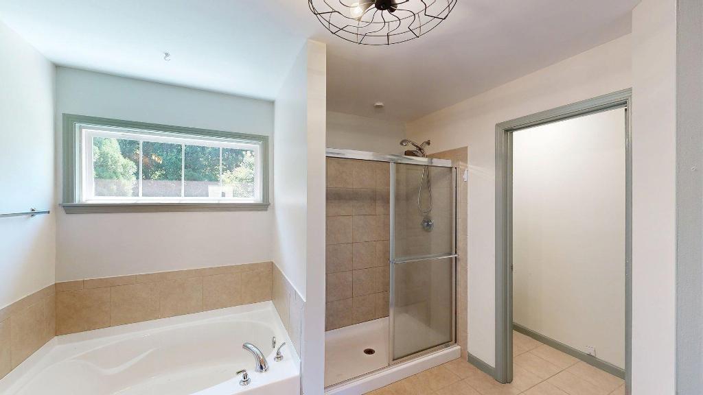 2499 Sinclair Trace Powder Springs, GA 30127 - Photo 22 of 42 a bathroom with a bathtub and a shower
