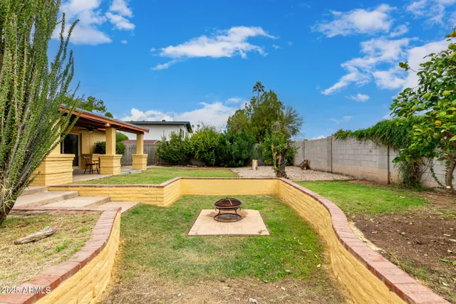 a swimming pool with outdoor seating and yard