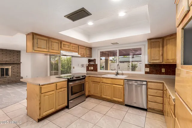 a kitchen with a stove sink and cabinets