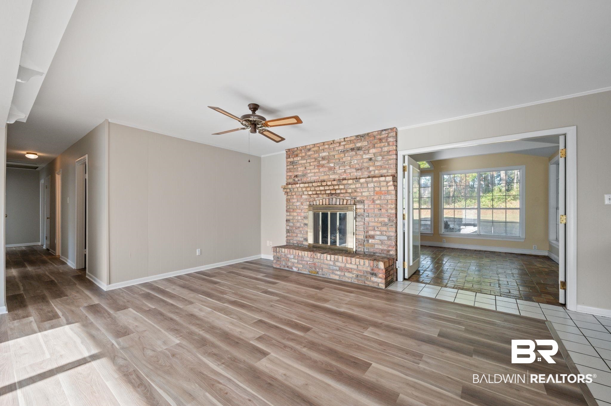 909 Caroline Avenue Daphne, AL 36526 - Photo 8 of 46 Unfurnished living room featuring a fireplace, hardwood / wood-style flooring, and ceiling fan
