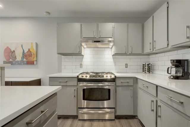 a kitchen with a stove and a sink