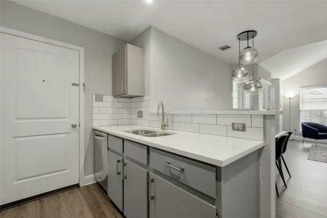 a kitchen with a sink and cabinets