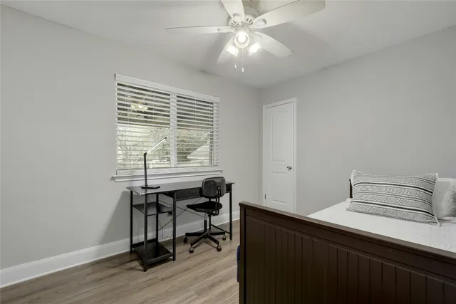 a view of a workspace with furniture and a window