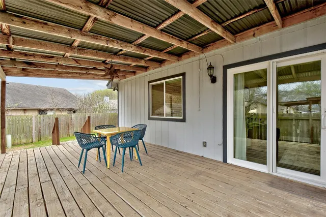 a view of a deck with table and chairs with wooden floor