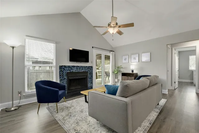 a living room with furniture a fireplace and a flat screen tv
