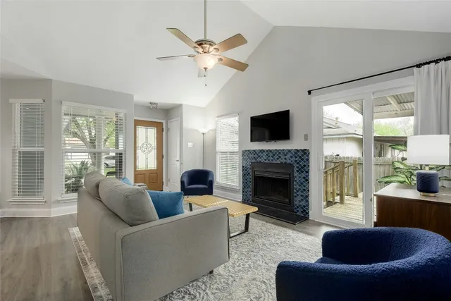 a living room with furniture a chandelier and a fireplace