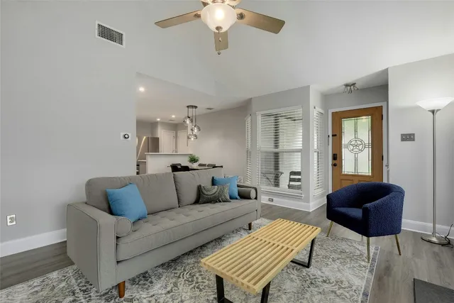 a living room with furniture and a chandelier