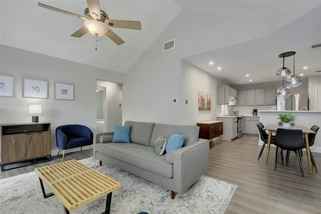a living room with furniture and a wooden floor
