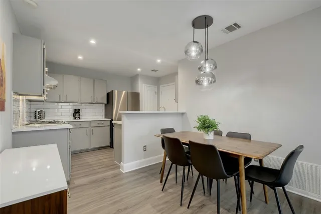 a kitchen with a table and chairs in it