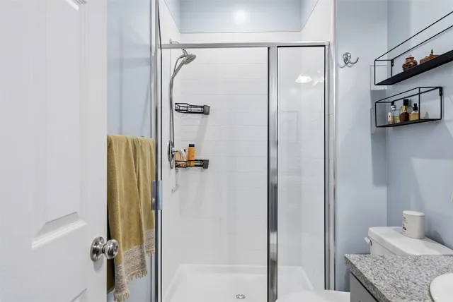 a bedroom with a large bed and a flat screen tv