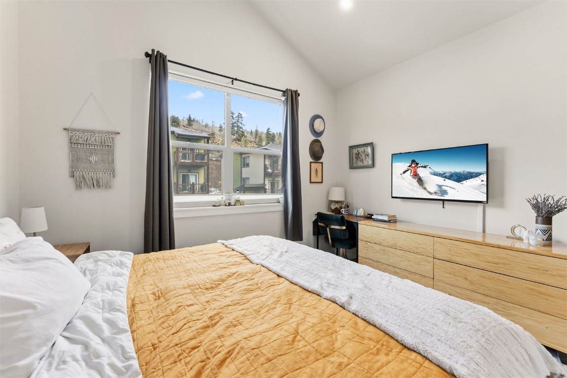 119 Wayback Drive, Unit 119 Keystone, CO 80435 - Photo 16 of 29 a bedroom with a large bed and a flat screen tv