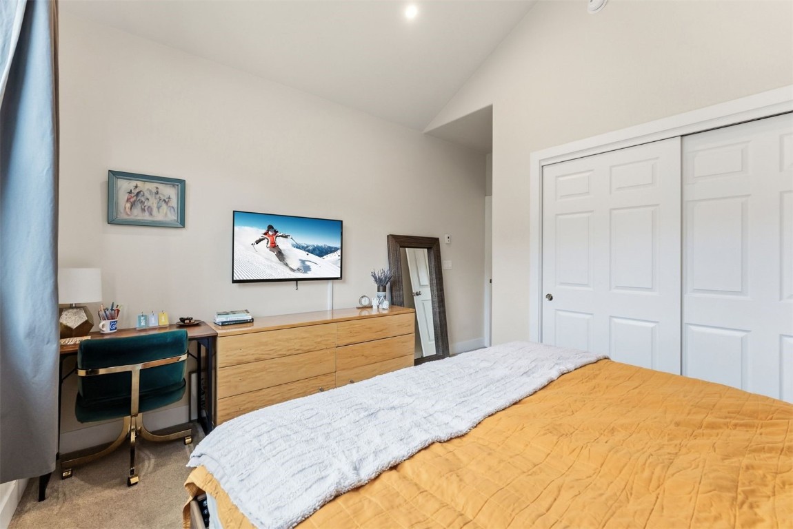 119 Wayback Drive, Unit 119 Keystone, CO 80435 - Photo 18 of 29 a bedroom with a bed and a flat screen tv