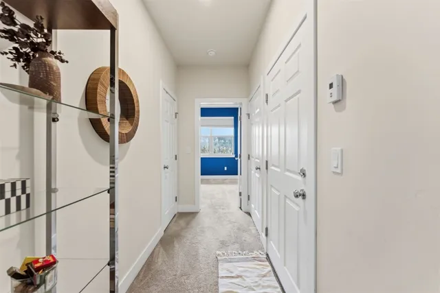 a view of a hallway with washer and dryer