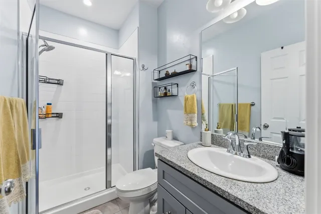 a bathroom with a sink a toilet and shower curtain