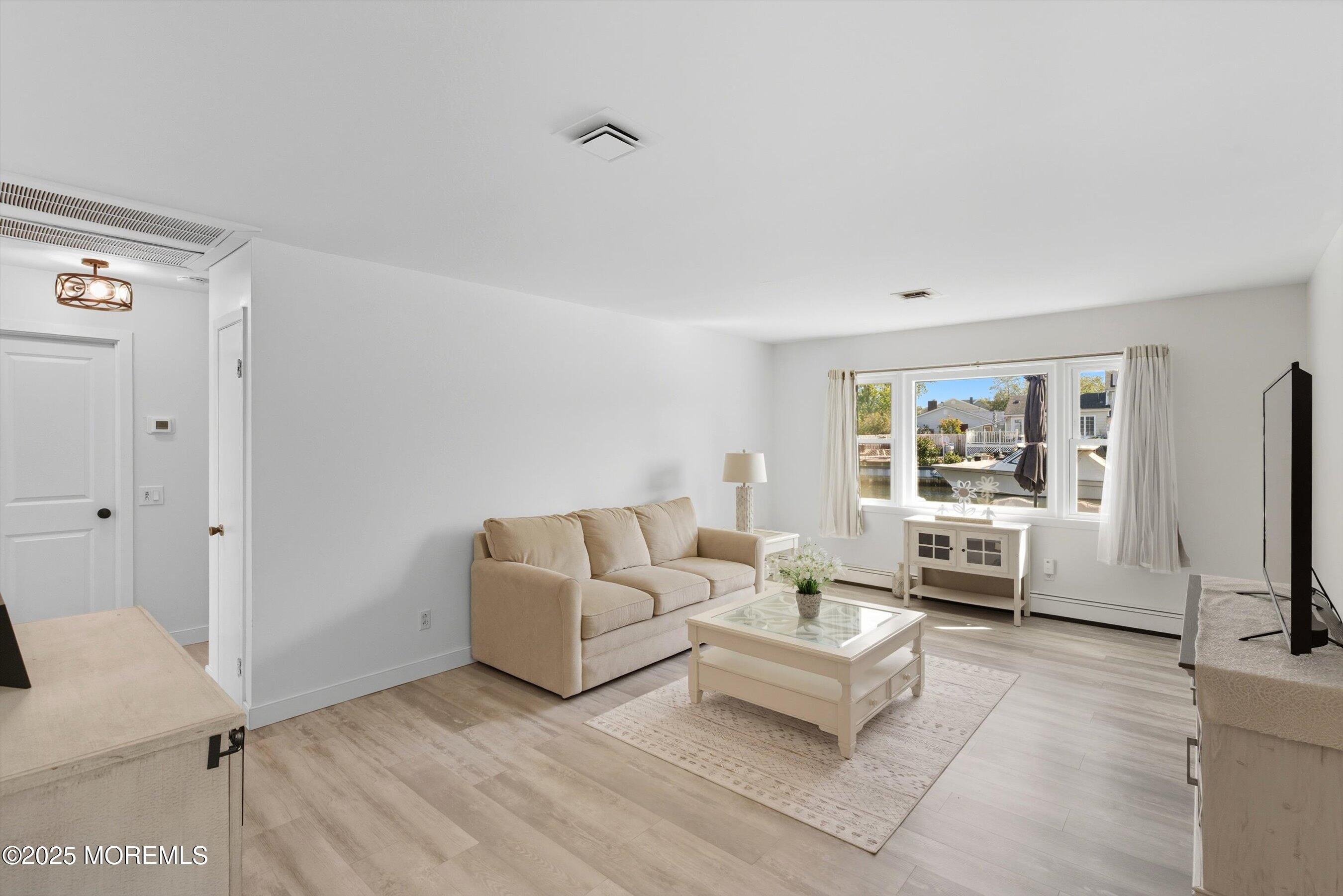173 Cliff Road Brick, NJ 08724 - Photo 21 of 37 a living room with furniture and a flat screen tv
