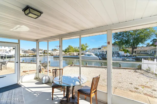 a dining room with furniture and floor to ceiling window
