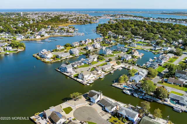 an aerial view of a house with a lake view
