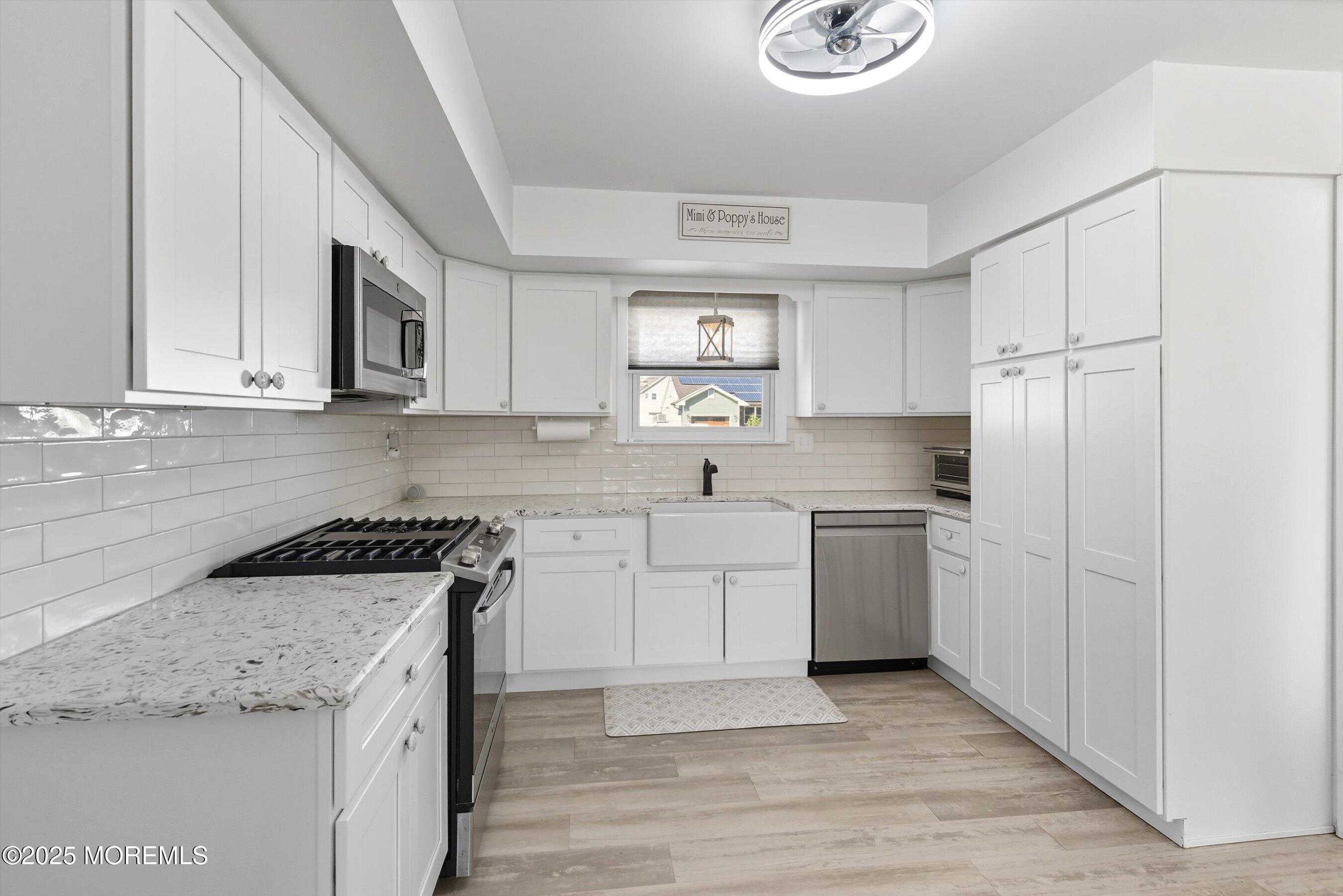 173 Cliff Road Brick, NJ 08724 - Photo 4 of 37 a kitchen with a sink cabinets stainless steel appliances and a window