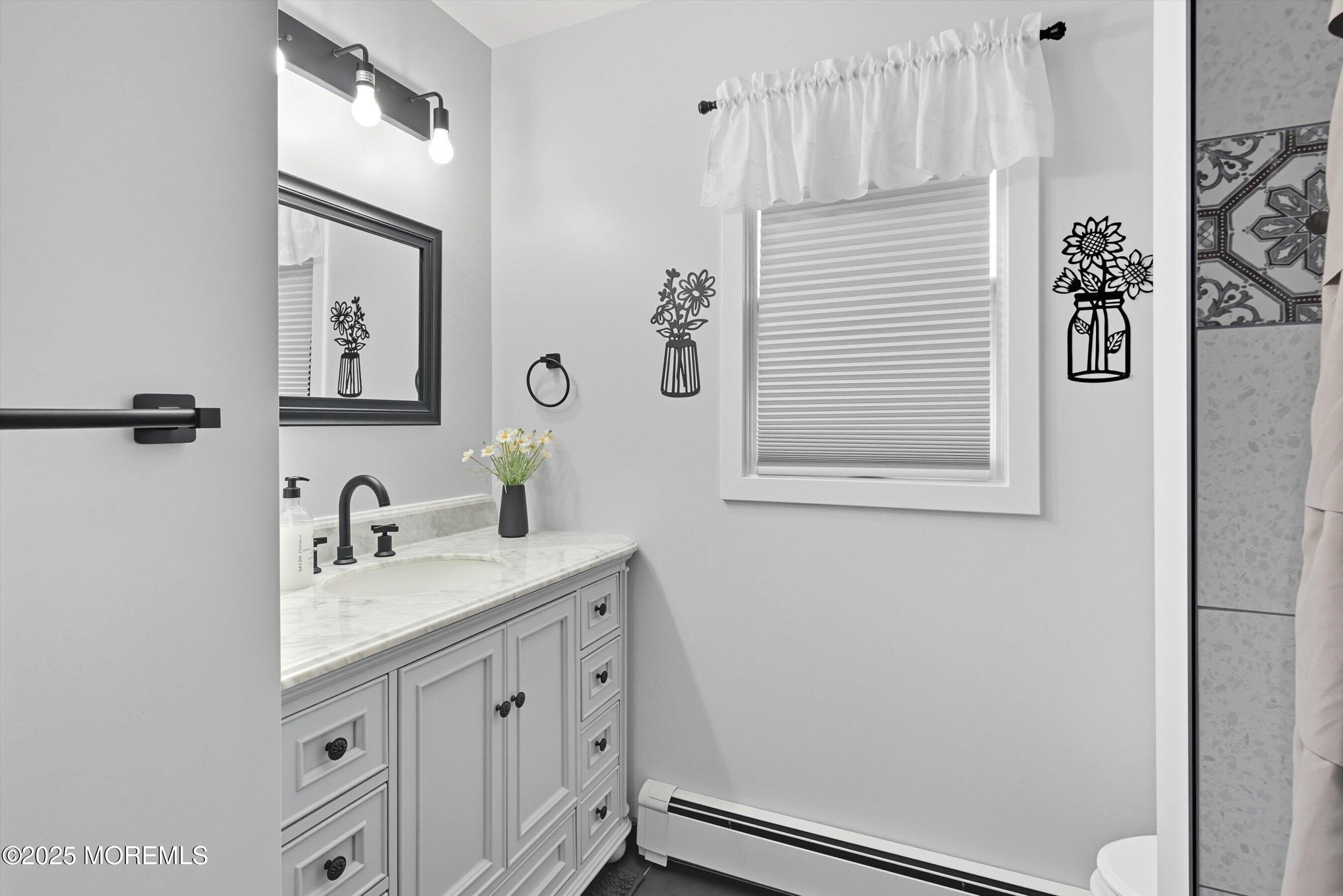 173 Cliff Road Brick, NJ 08724 - Photo 10 of 37 a bathroom with a sink and a mirror