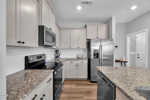 a kitchen with a sink stove and refrigerator