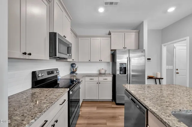 a kitchen with a sink stove and refrigerator