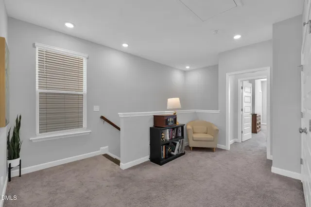 a view of a livingroom with furniture and a window