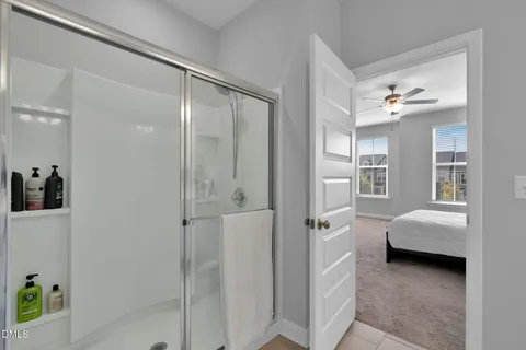 a bathroom with a tub shower vanity and a sink