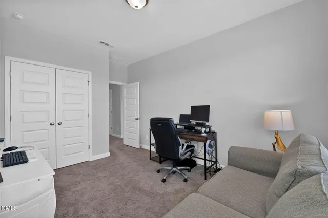 a view of a livingroom with workspace and a couch