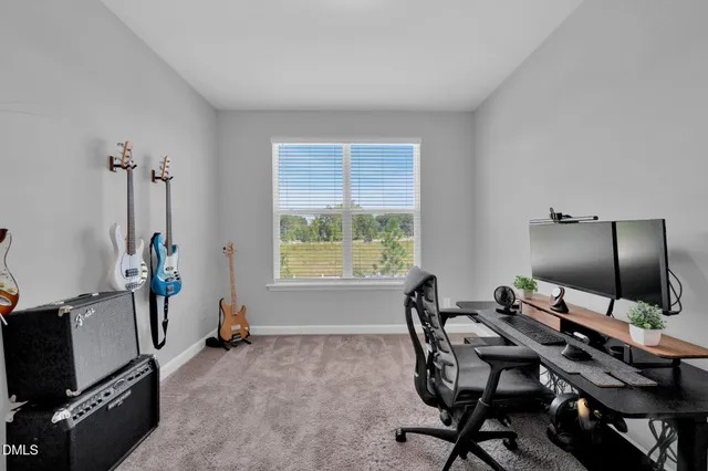 a view of a workspace with furniture and a window