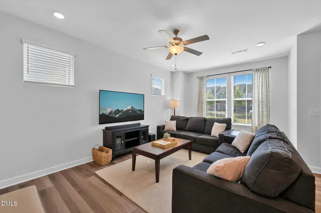 a living room with furniture a window and a flat screen tv
